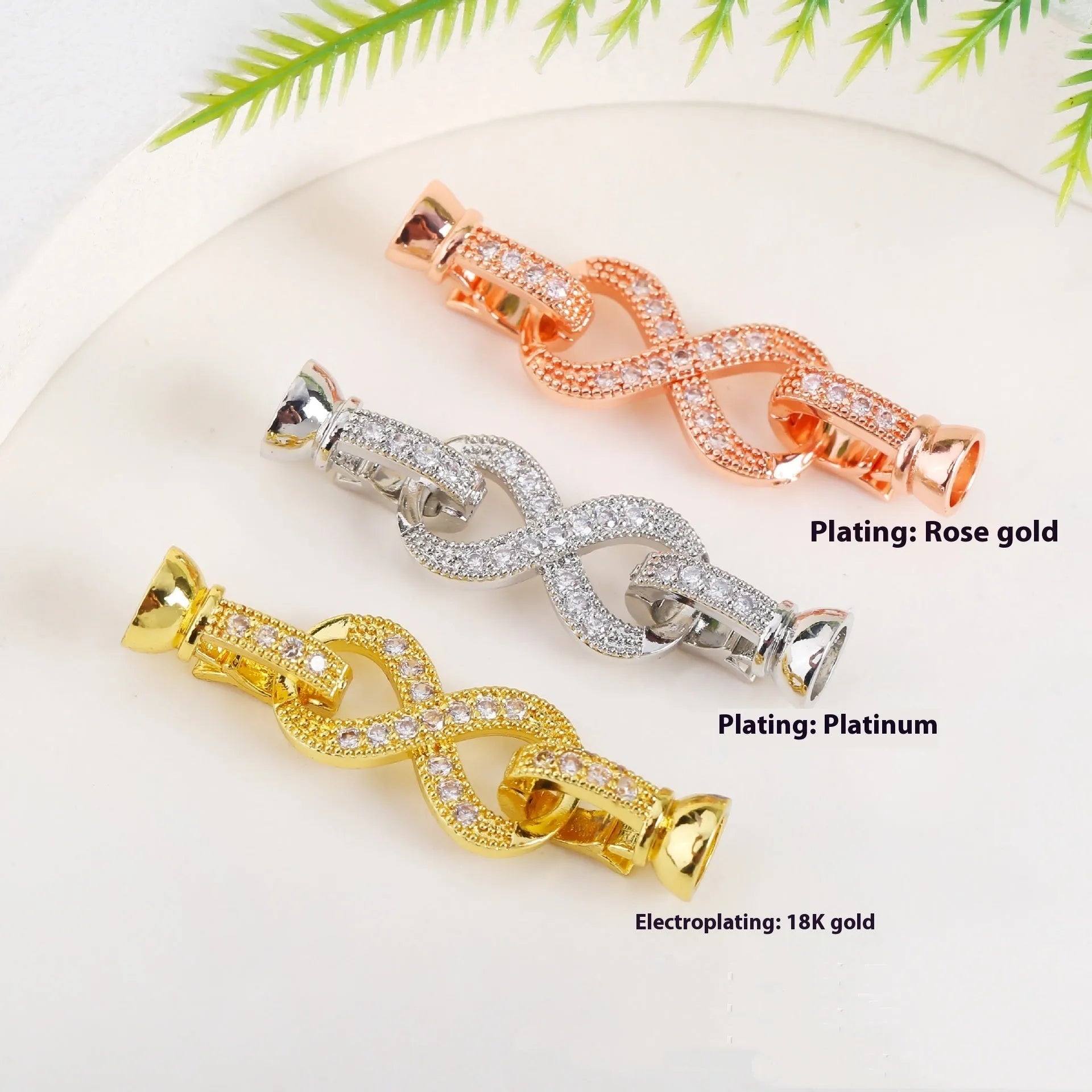 Small gold colour necklace clasp buckle for DIY jewellery on a white background.
