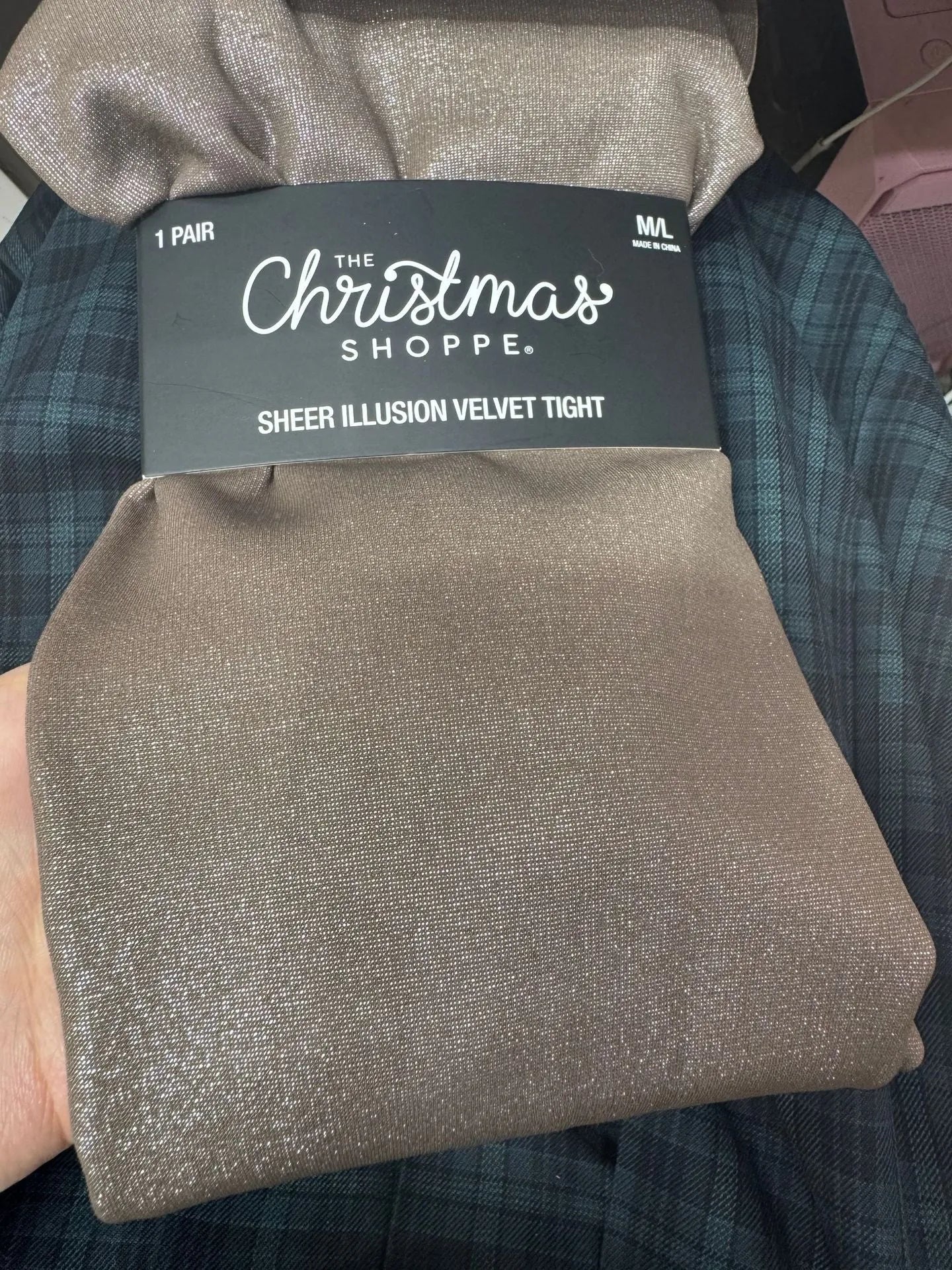 Women's black thermal leggings with a wool lining, shown in a flat lay.