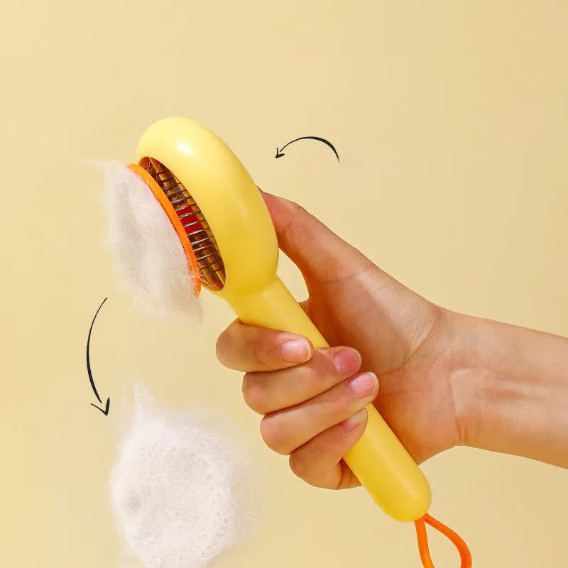 Small yellow duck-shaped pet comb with open sections and floating needles for cat and dog hair removal