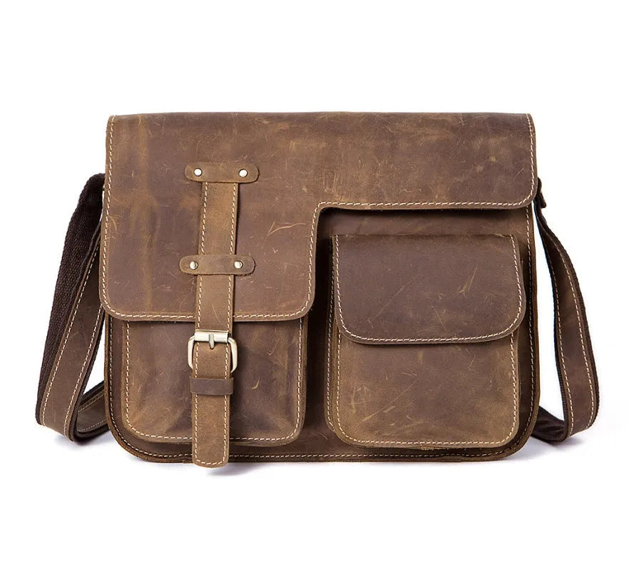 Brown leather vintage messenger bag with crossbody strap open showing laptop compartment