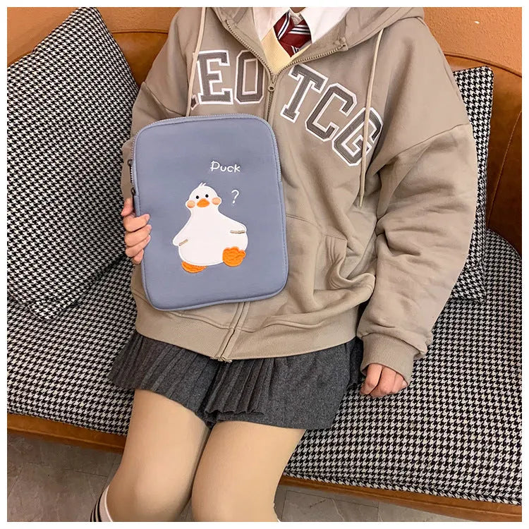 Blue cotton tablet case with embroidered cartoon duck design and zipper opening