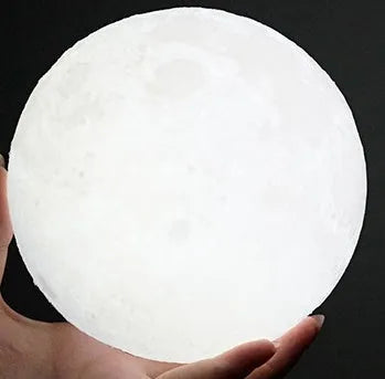 3D printed white moon lamp on wooden stand with colour-changing LED light