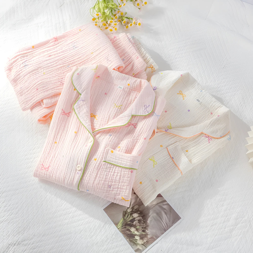 Women's beige long sleeve cotton pajama set with trousers, laid flat.