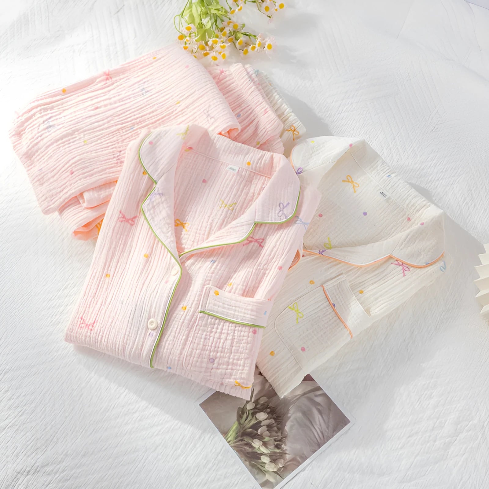 Women's beige long sleeve cotton pajama set with trousers, laid flat.