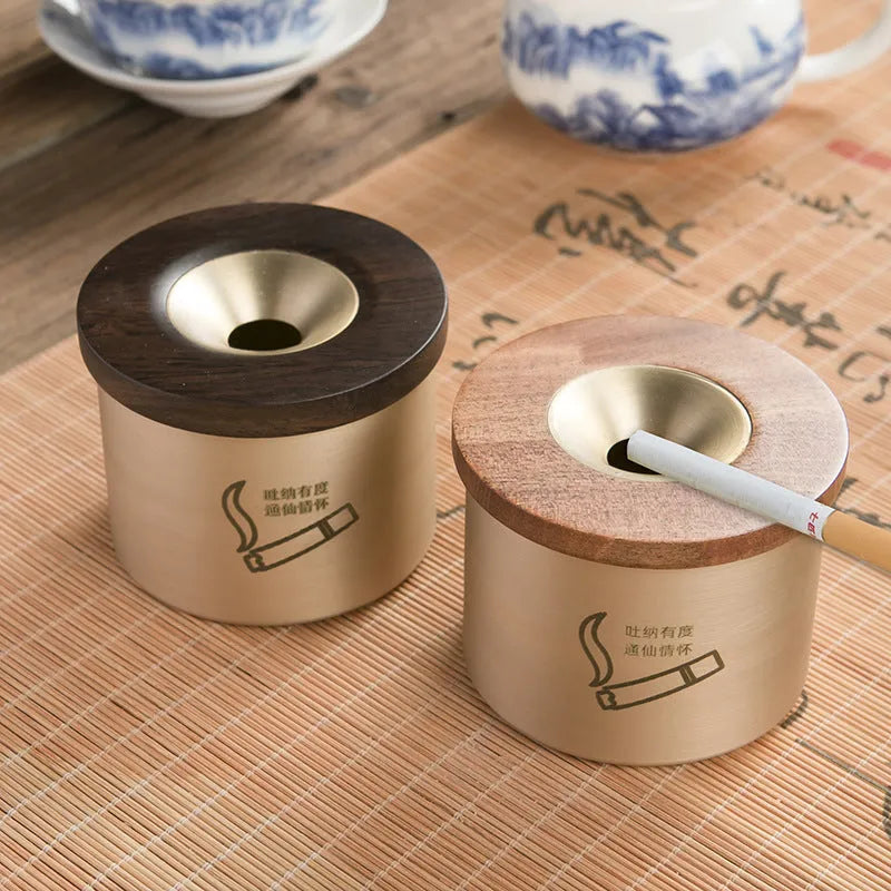 Brass retro ashtray with wooden lid in copper finish on living room table