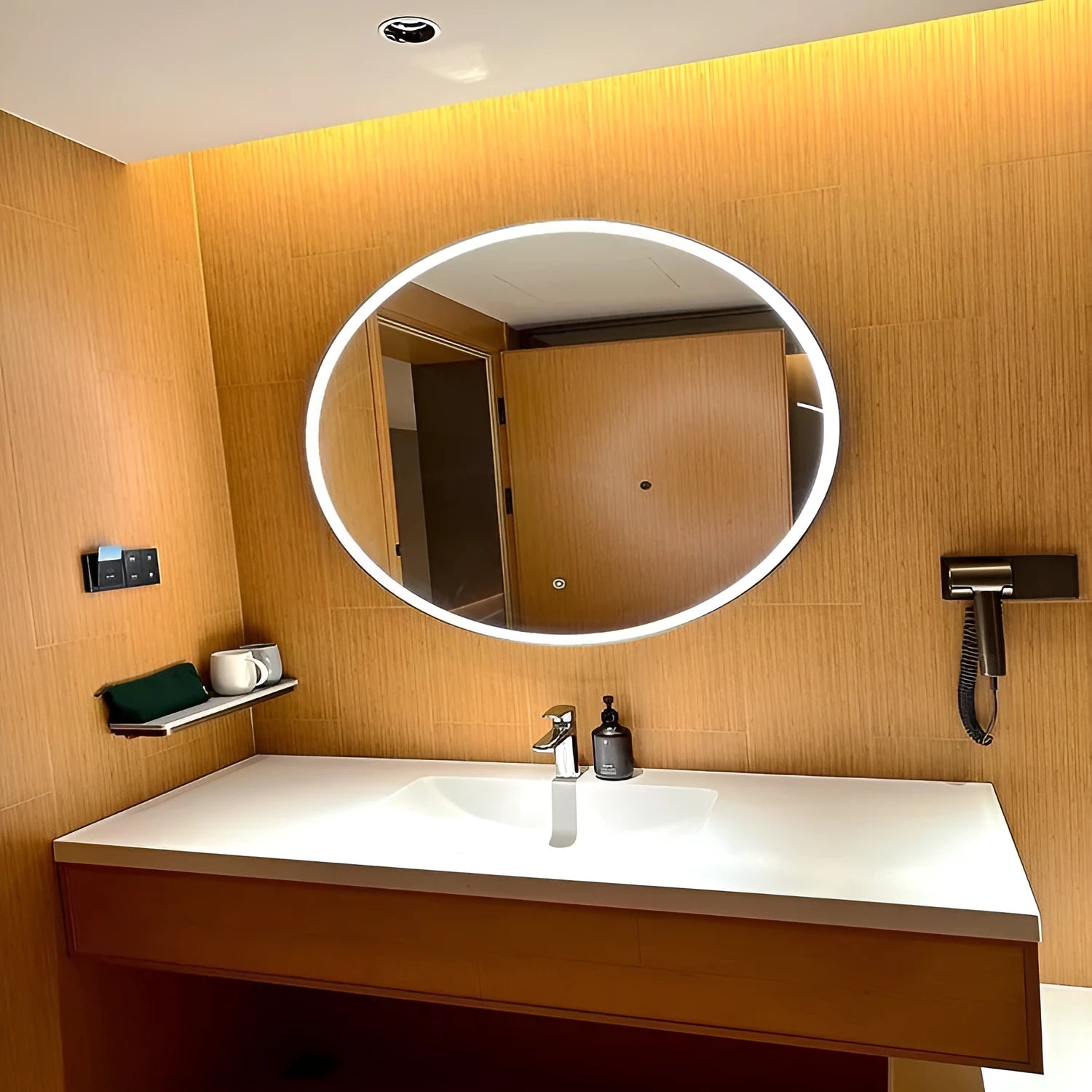 Round black frame bathroom mirror with LED lighting mounted on wall