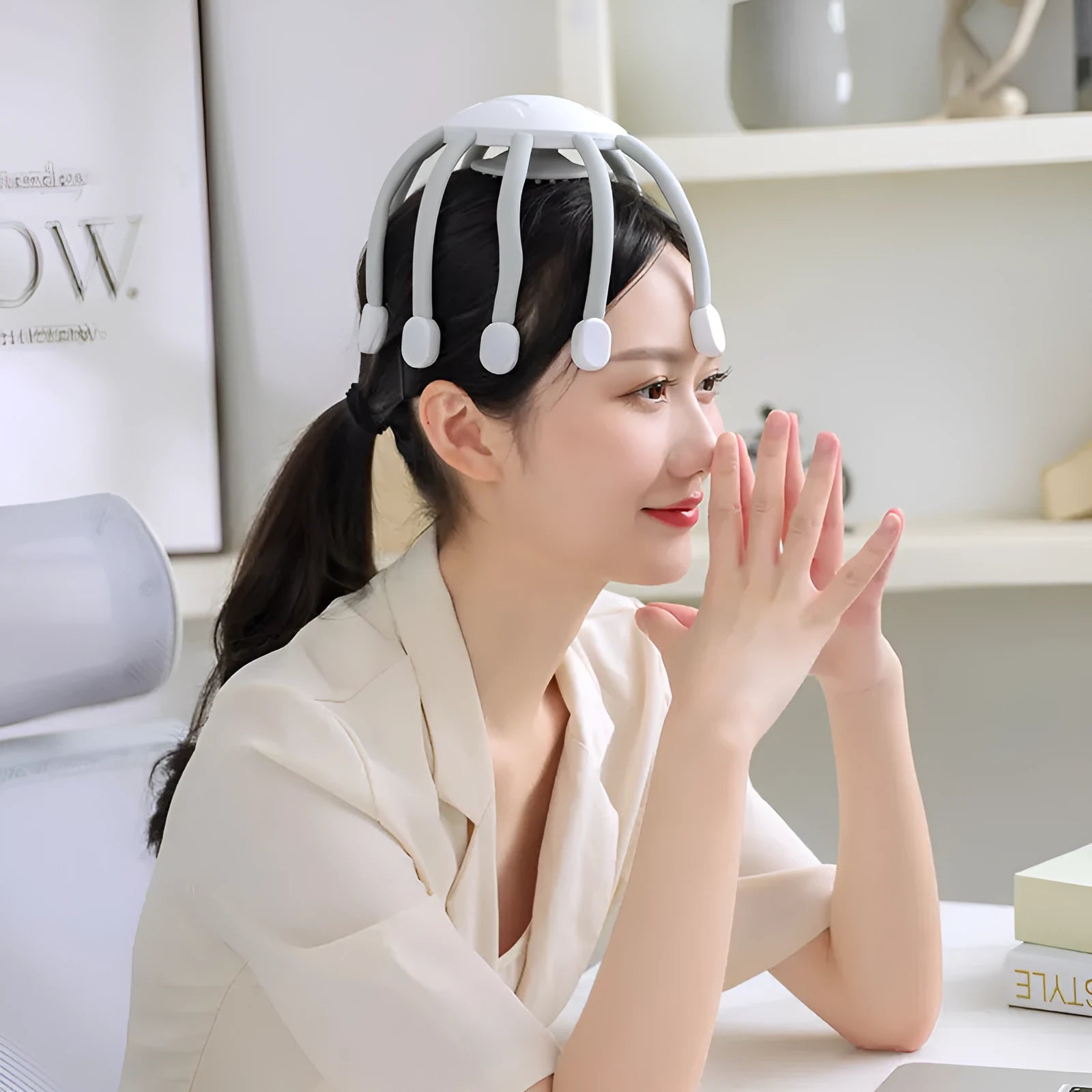 Black head massager with multiple vibrating claws on a scalp, showing four speed mode buttons and USB charging port