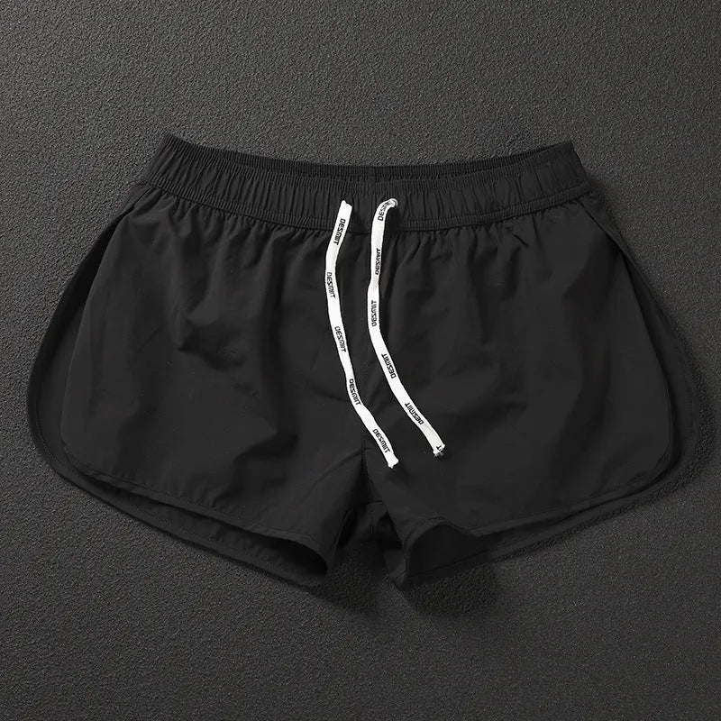 Men's loose beach shorts in orange, fluorescent green, and black colours with elastic waist