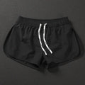 Men's loose beach shorts in orange, fluorescent green, and black colours with elastic waist
