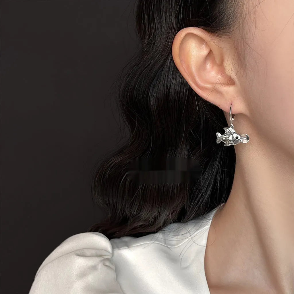 A pair of copper fish earrings with an electroplated goldfish bubble design.