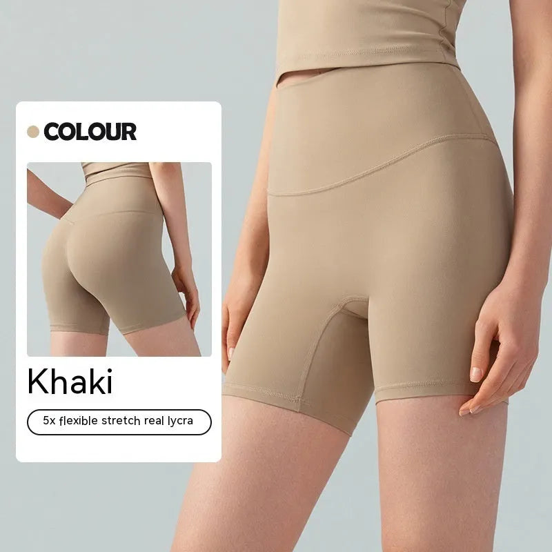 Women's high-waisted Lycra yoga shorts in leaf green, showing anti-exposure construction and short length.