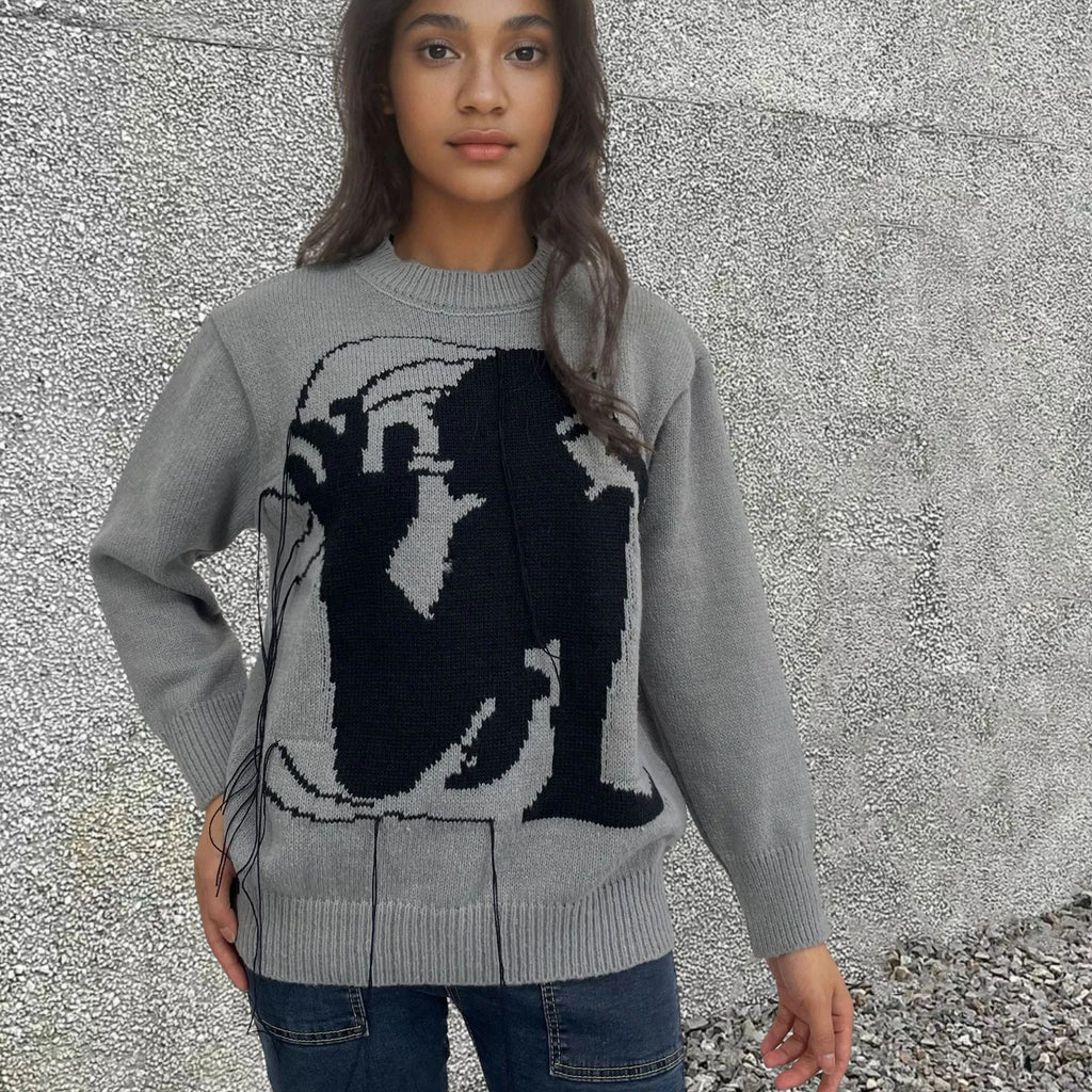 Grey women's loose alpaca wool sweater with a round neck, regular sleeves, and a long tassel detail.