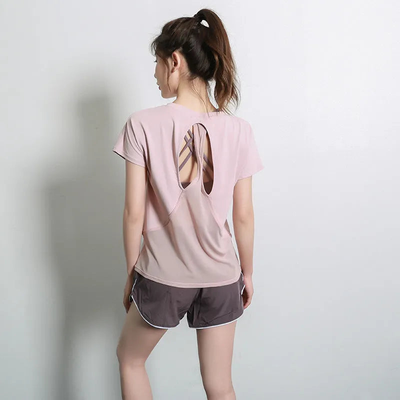 Women's short sleeve polyester fitness t-shirt in pink, shown for sports and gym wear.