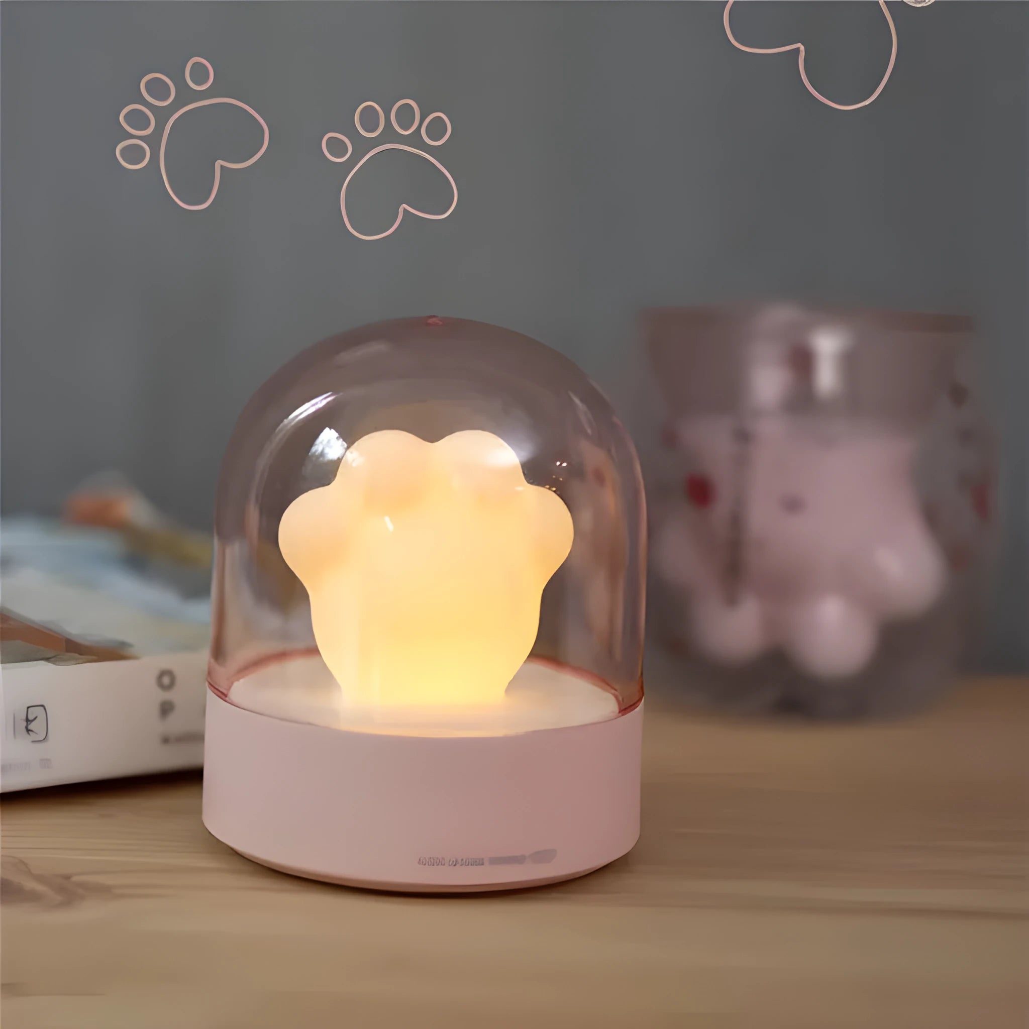 Grey or pink cat paw shaped USB rechargeable night light with musical functions on wooden desktop
