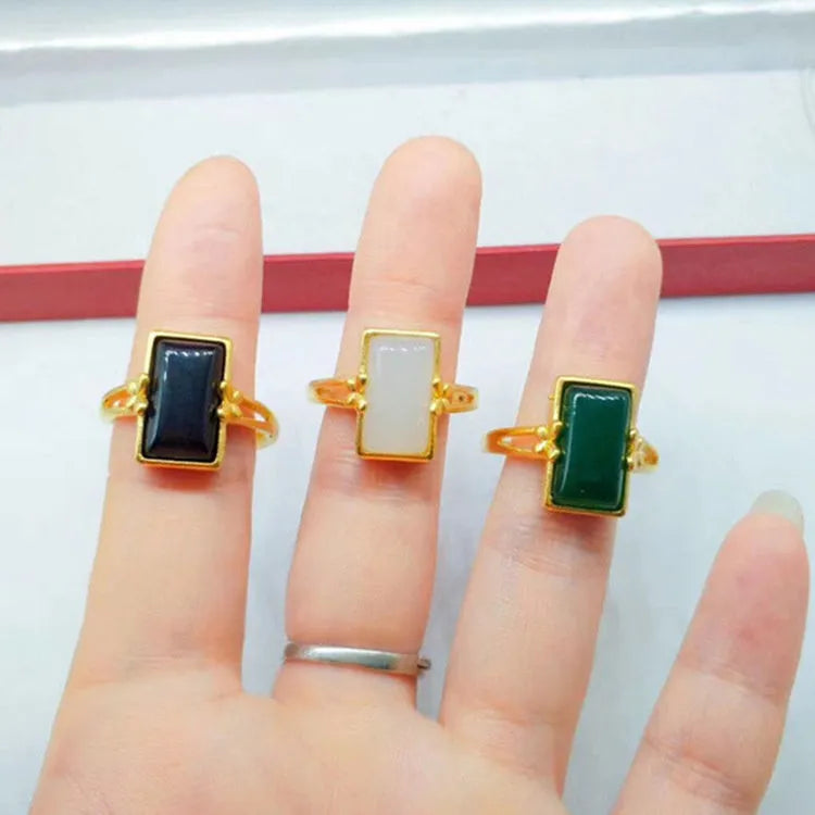 Adjustable brass ring with gold plating and coloured gemstone in national style design