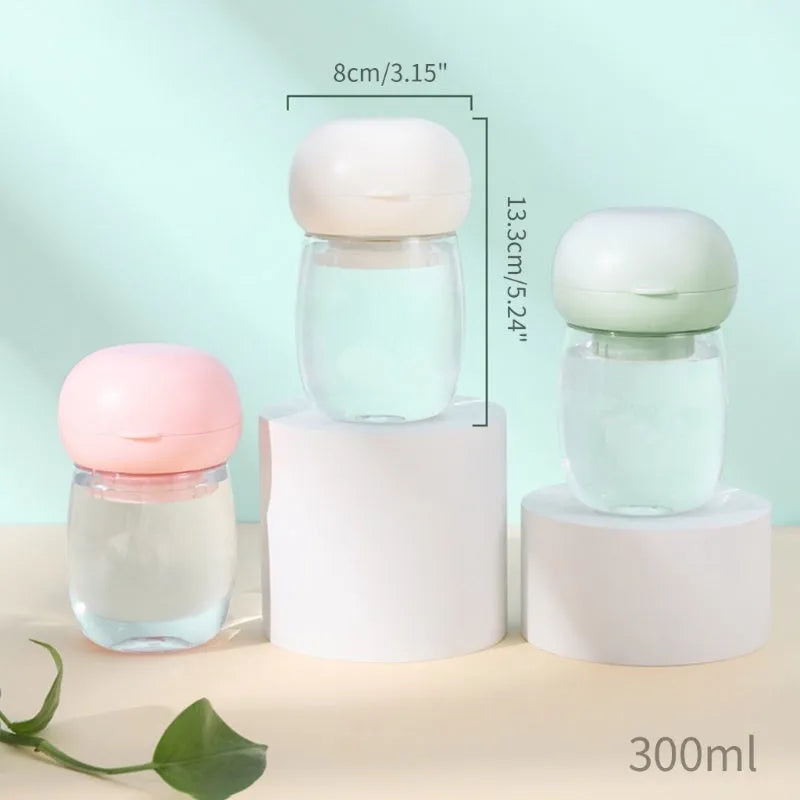 Portable dog water bottle with press-button cup in white on a green background