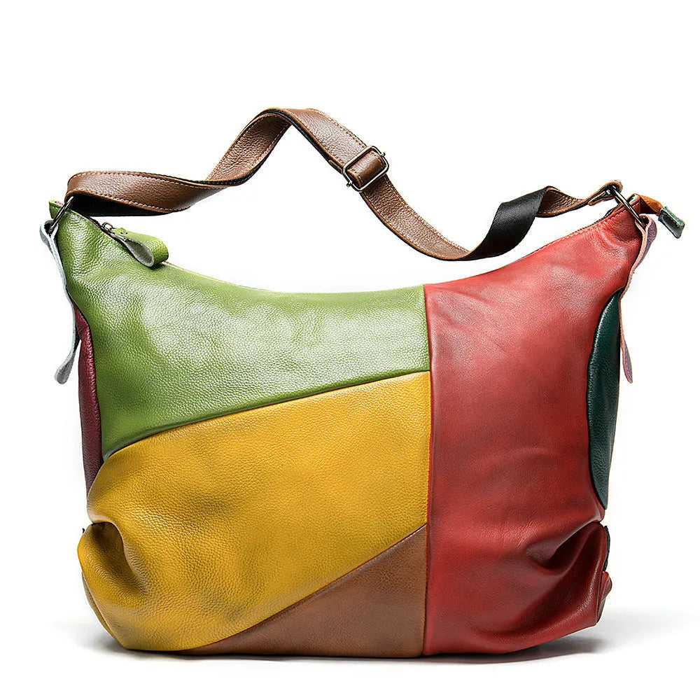 Cowhide leather crossbody travel bag showing stitching detail and capacity for 15-inch laptop