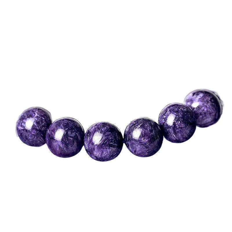 Natural purple charoite crystal bracelet with platinum details, showing different bead size options.