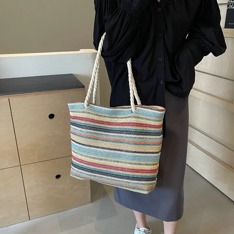 Blue straw-woven nylon shoulder bag with large main compartment and single strap