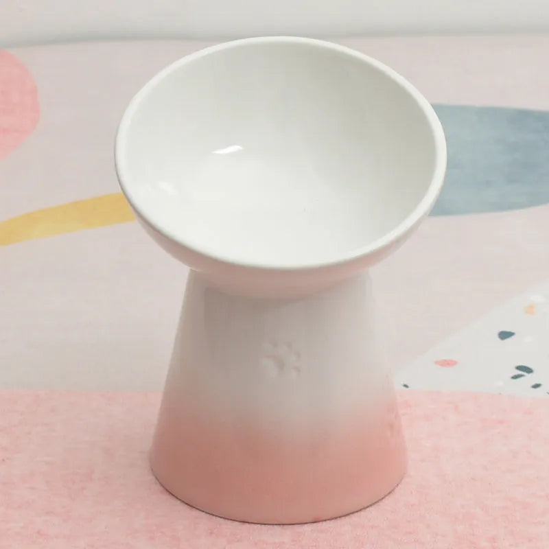 A white ceramic pet bowl with a high foot and raised neck protector to prevent tipping.