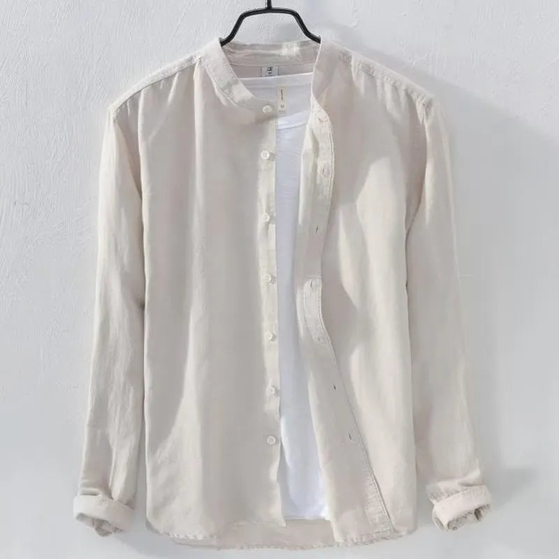 Man's loose fit long sleeve linen shirt in dark blue, showing button front and casual style.