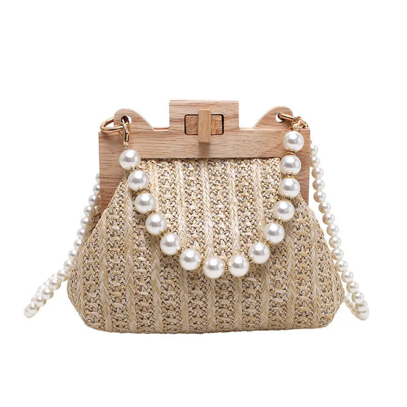 Women's woven straw shoulder bag with pearl chain strap showing interior organiser compartments