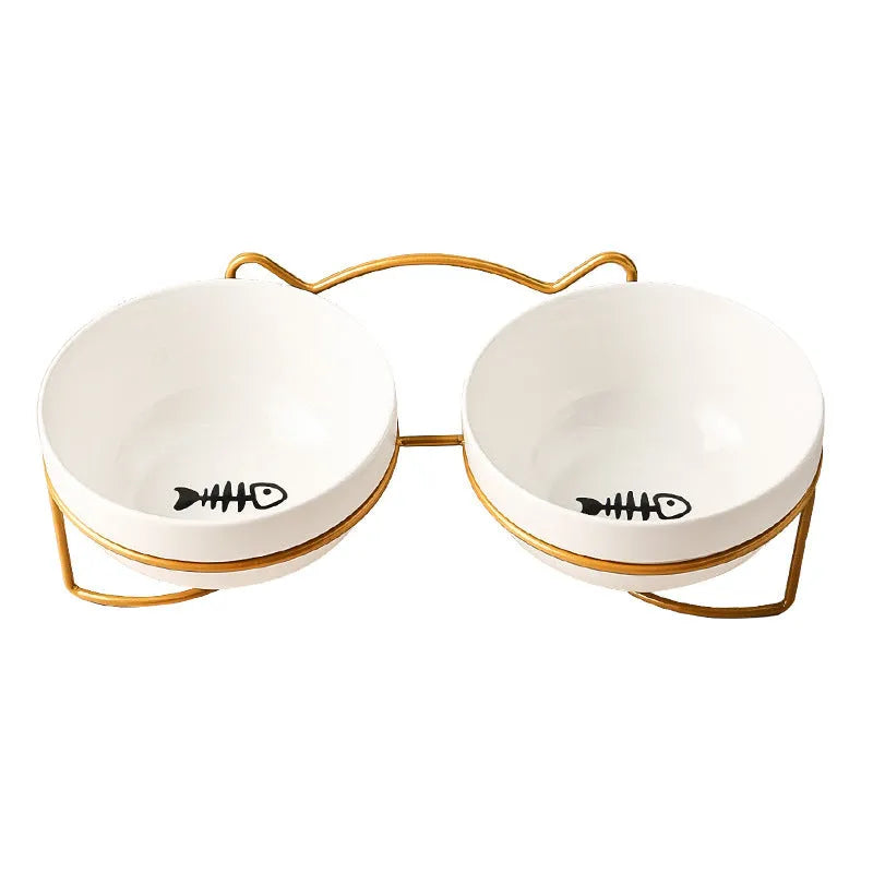 Ceramic cat bowl with iron frame stand showing cat paw print pattern and gold metal finish