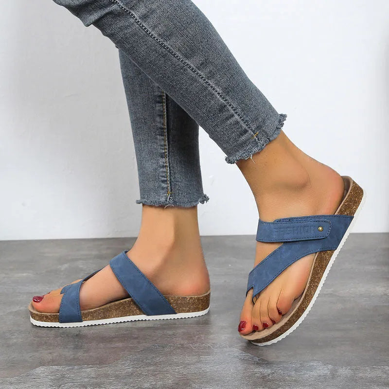 A pair of flat toe ring thick-soled flip-flops in a solid colour on a plain background.