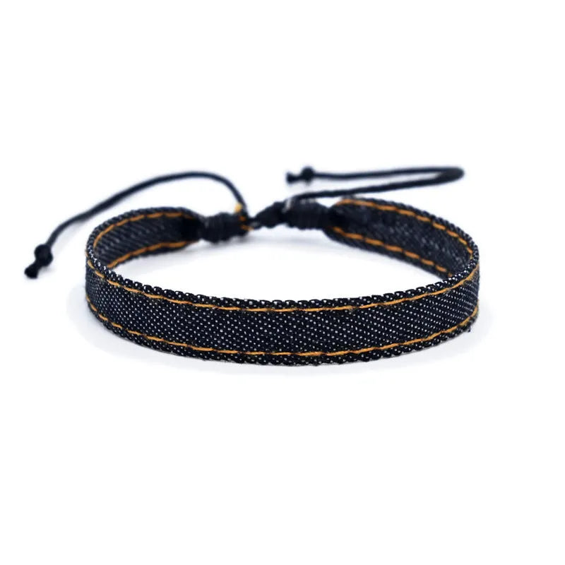 Handmade denim fabric wristband carrying strap in mixed materials with adjustable closure