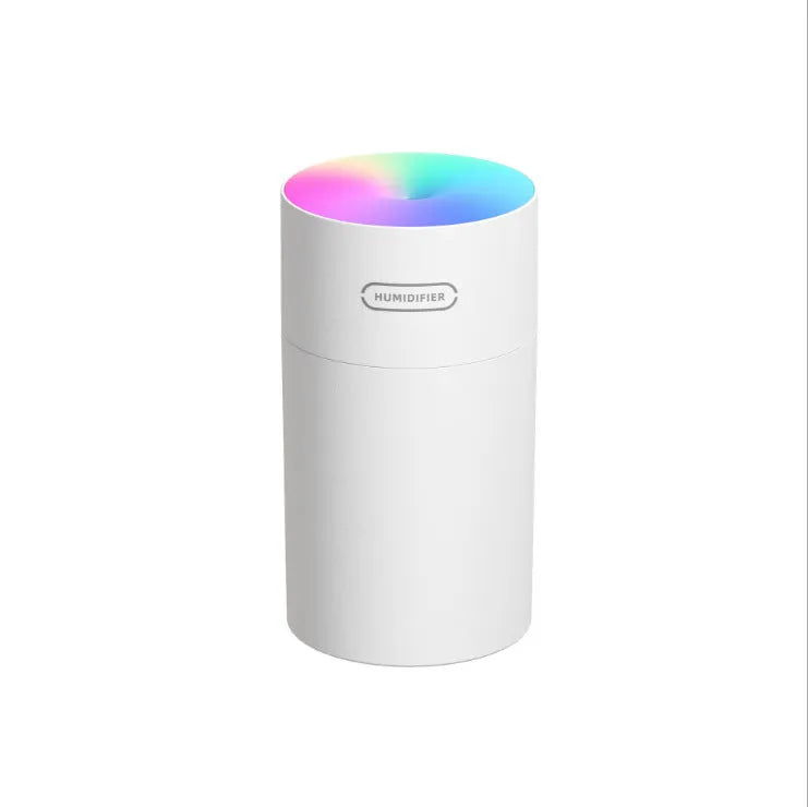 Pink USB portable humidifier with 300ml water tank on wooden desk surface