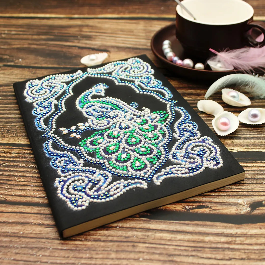A5 black hardcover diamond painting notebook kit with peacock design, shaped drills, and bright drills.