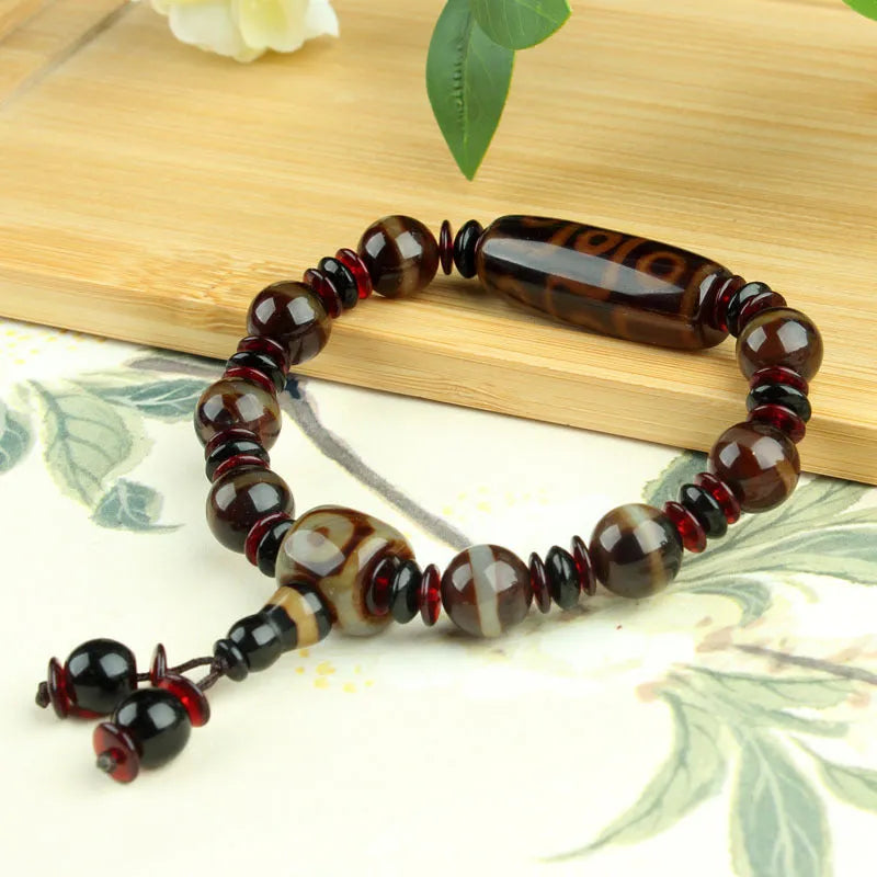 Agate Tibetan dzi bead bracelet with three-eye design and polished finish