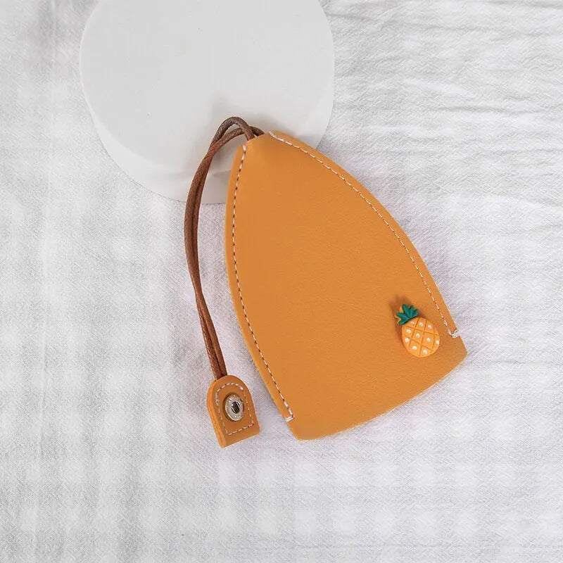 Cartoon pull-out key case in PU leather showing design options including resin fruit and big cartoon animal prints.