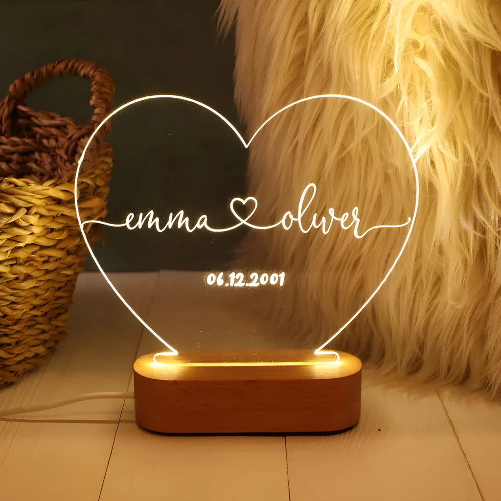 Custom engraved acrylic LED night light showing illuminated personal names and dates