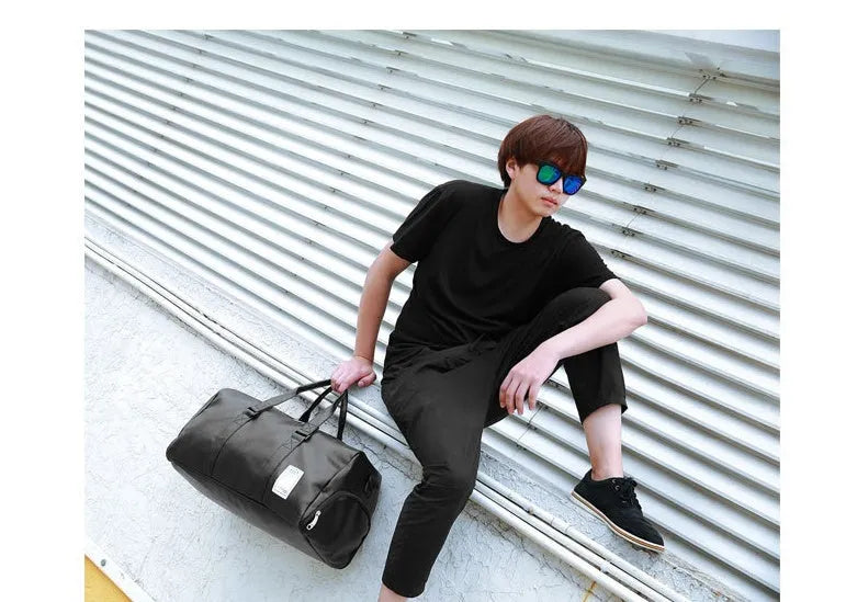 Black waterproof sports bag with side shoe compartments showing diagonal straps and two size options