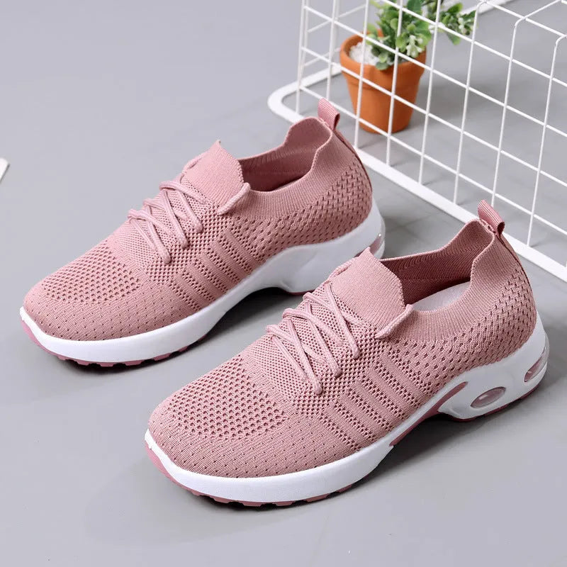 Women's black casual sneakers with mesh upper and non-slip PVC soles, shown with lace-up front closure