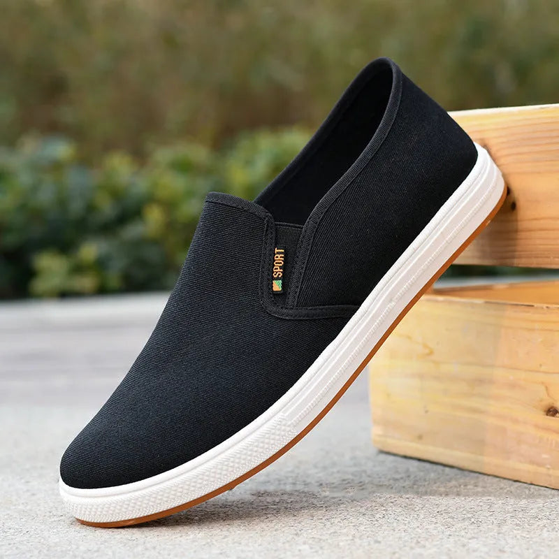 Men's black and blue canvas slip-on shoes with round toe design and composite soles
