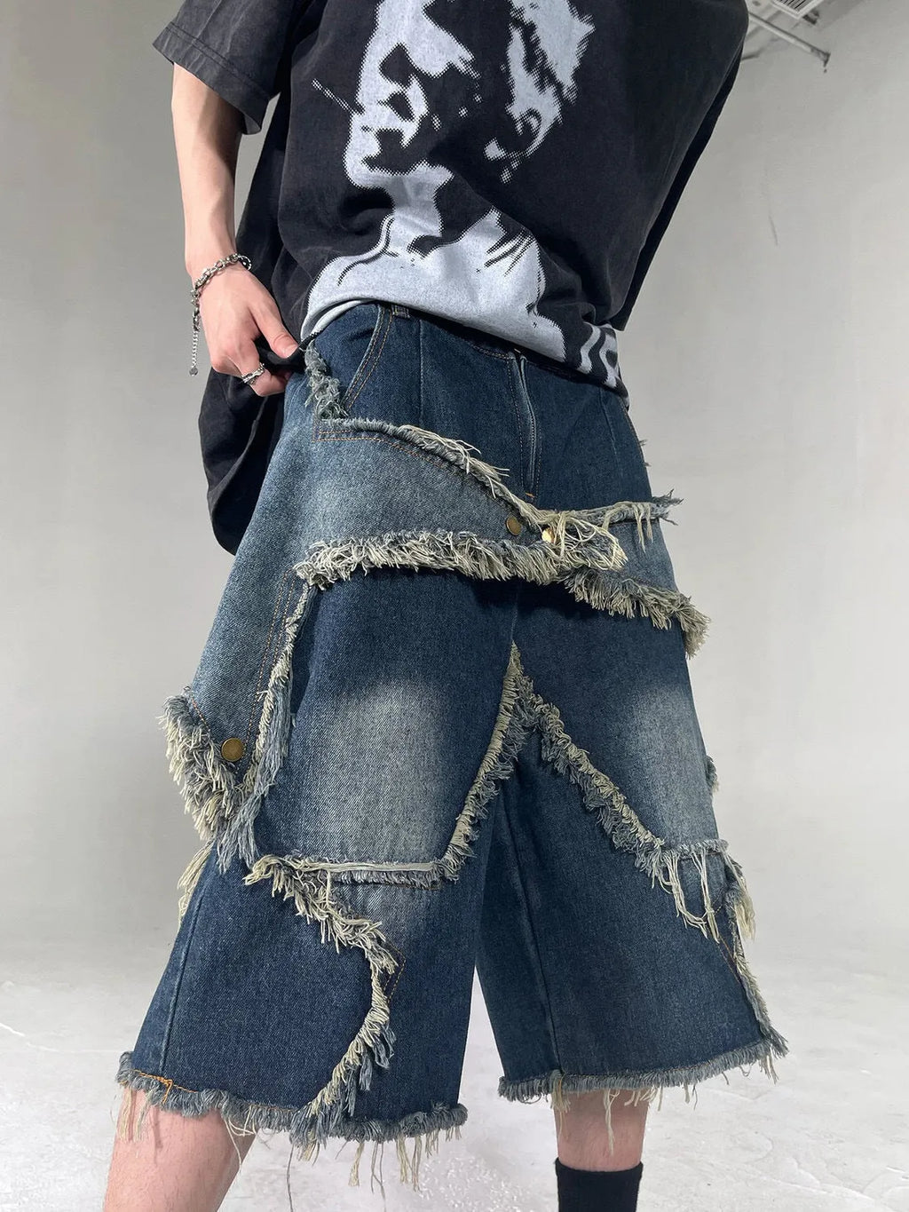 Blue denim shorts with frayed detailing and five-pointed star design in loose fit