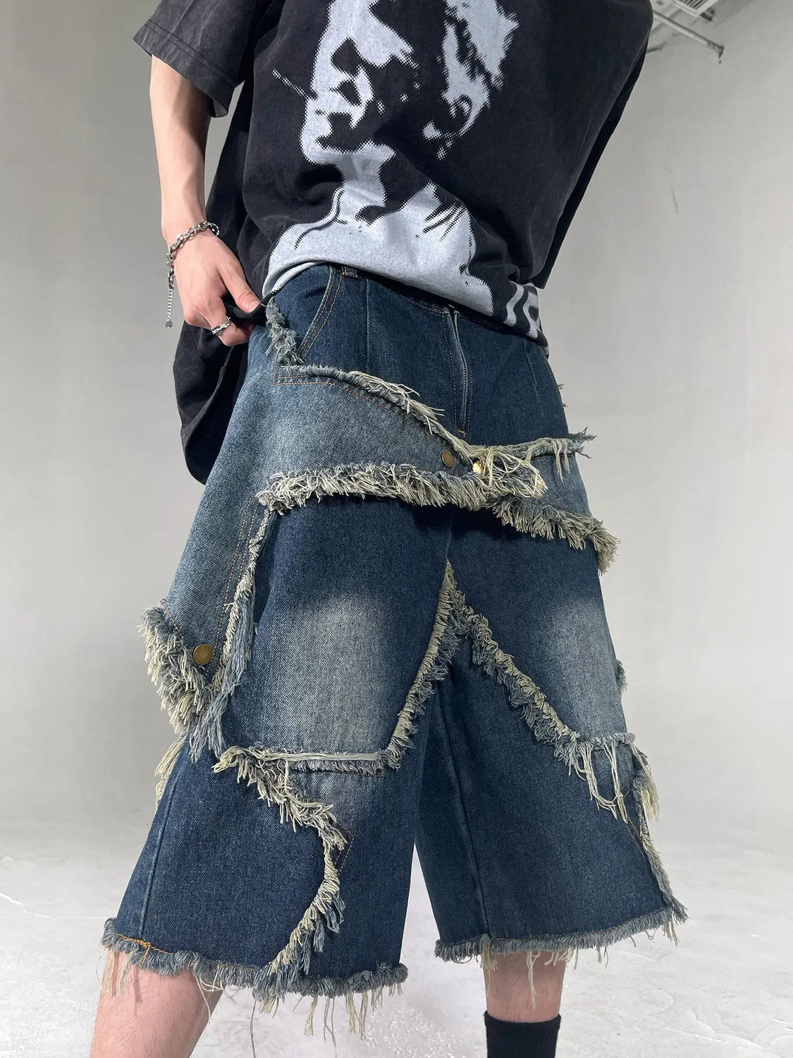 Blue denim shorts with frayed detailing and five-pointed star design in loose fit