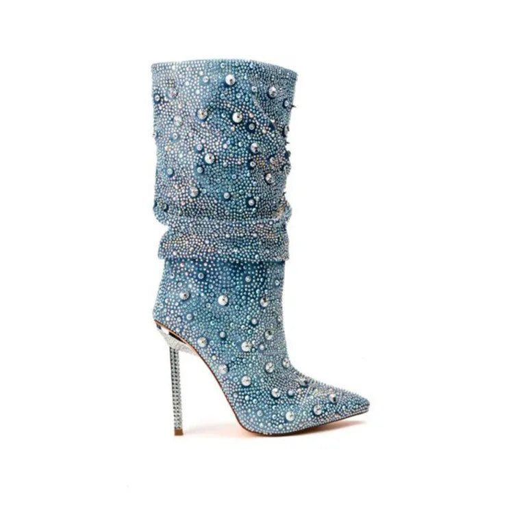 Women's blue denim pointed toe heel boots with stretchy fit on a plain background