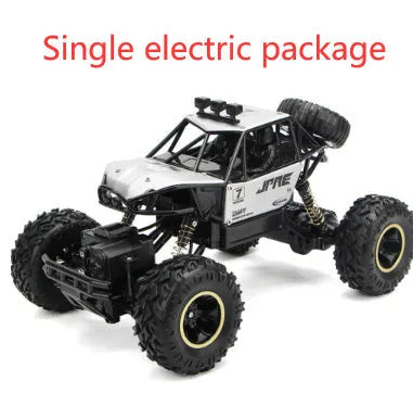 Large black or silver 4WD remote control climbing car on off-road terrain with wireless remote.