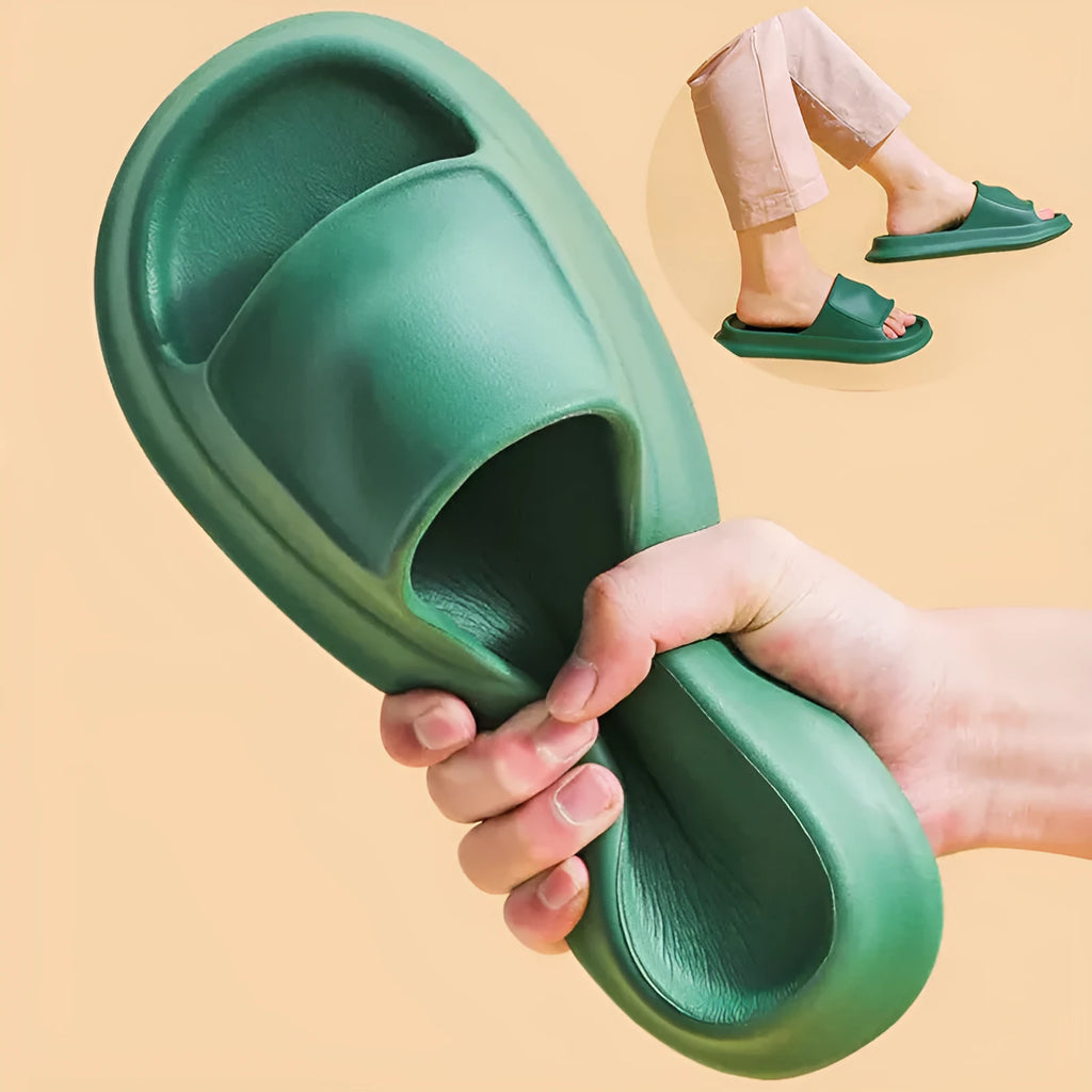 Pair of thick-soled EVA flip flop slippers in purple, showing deep sole profile.