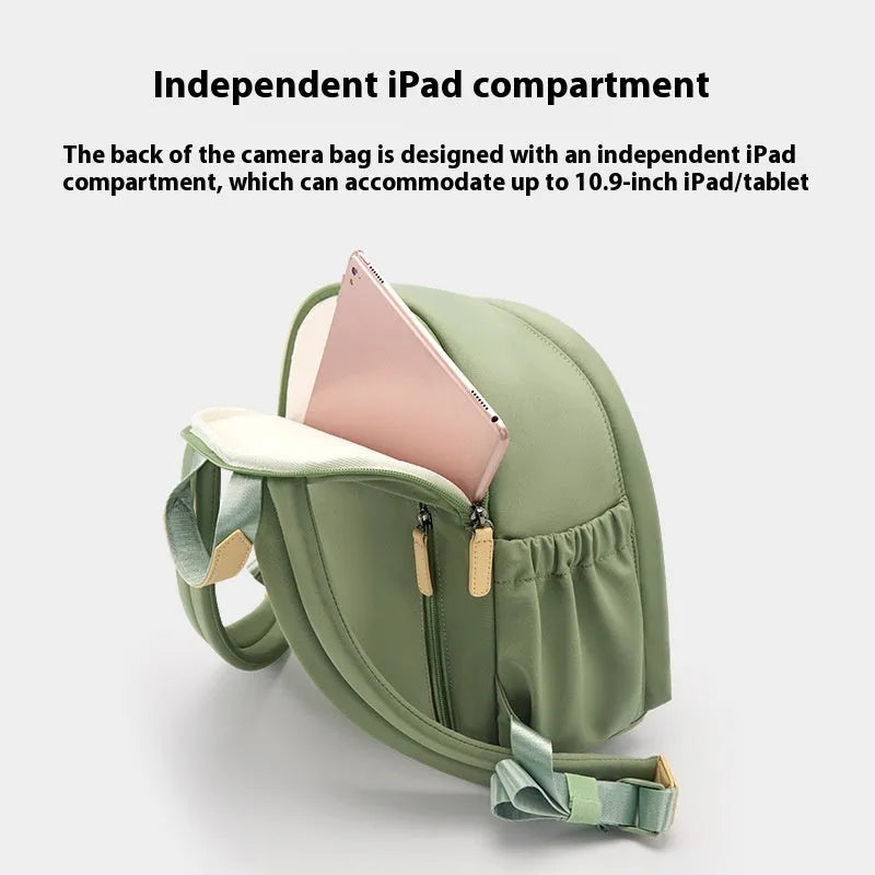 Women's polyester shoulder camera bag in black with a curved strap and detachable iPad pocket.