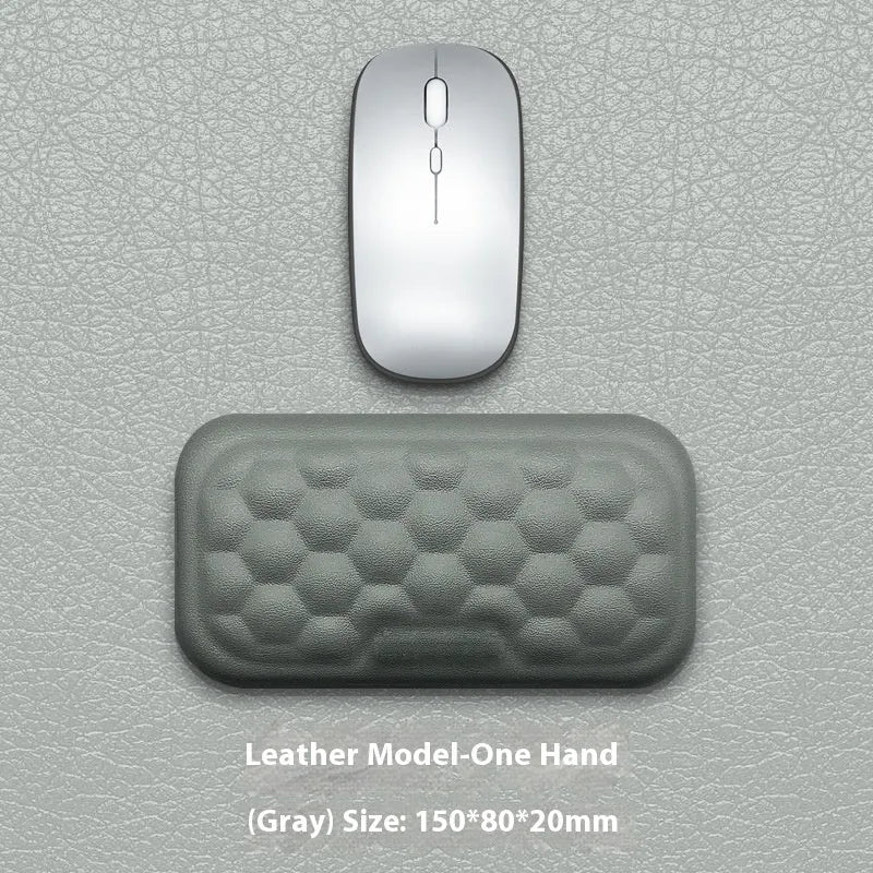 Customisable memory foam mouse wrist pad with black cloth cover on a desk.