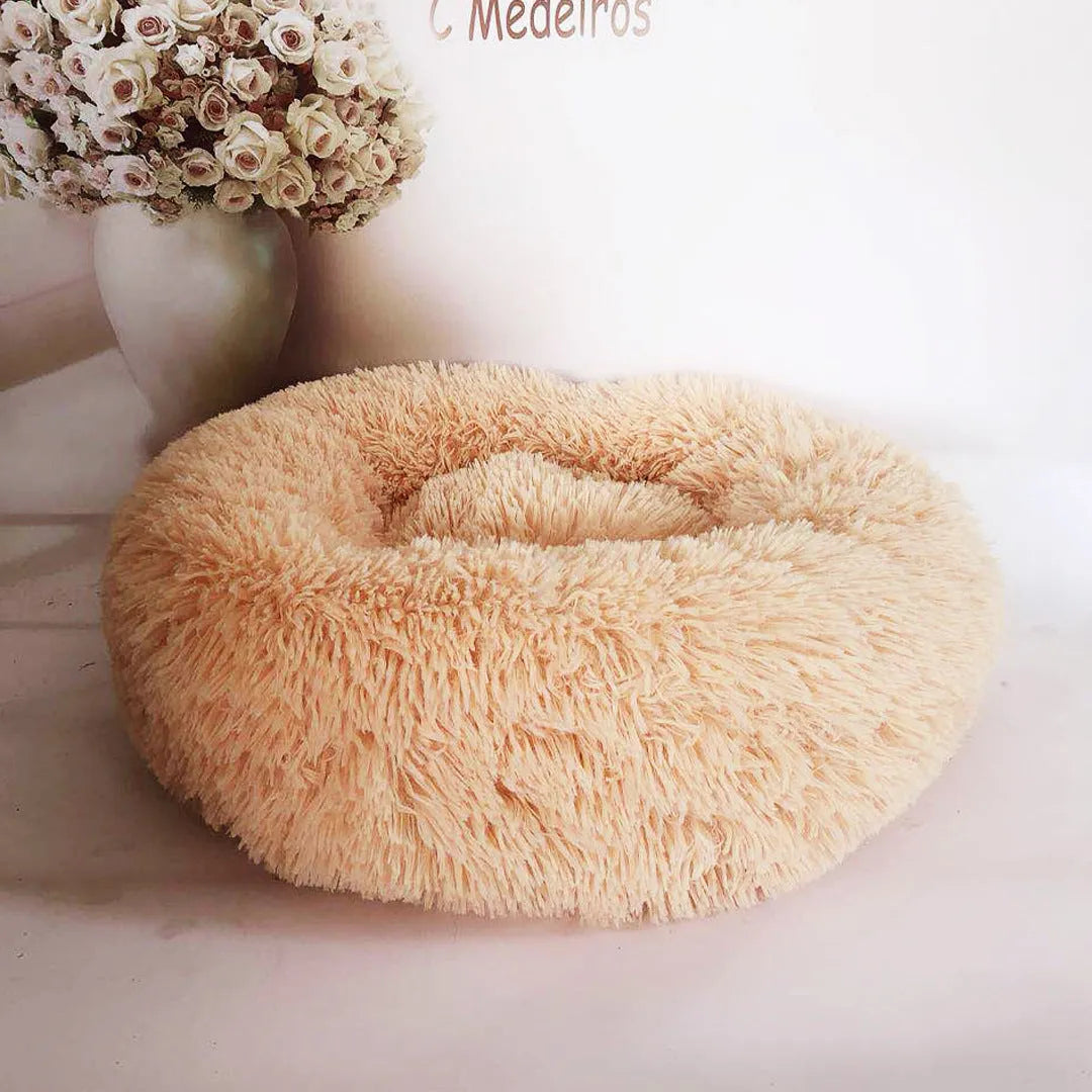 Plush pet nest in apricot colour on floor, soft cloth circular dog bed 40cm diameter indoor use