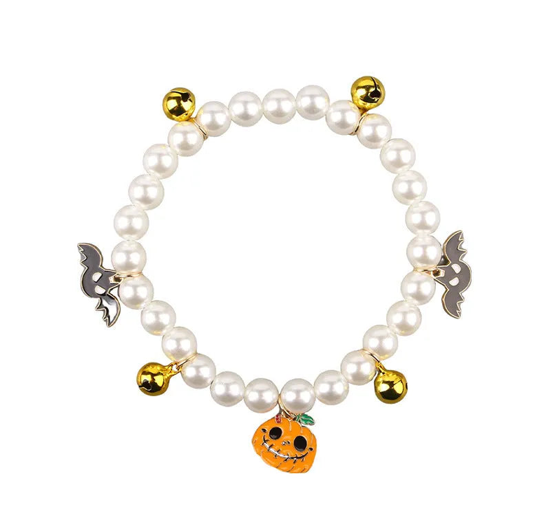 Halloween cat collar with simulated pearls and pumpkin charms in purple ghost, skull, and smiling designs
