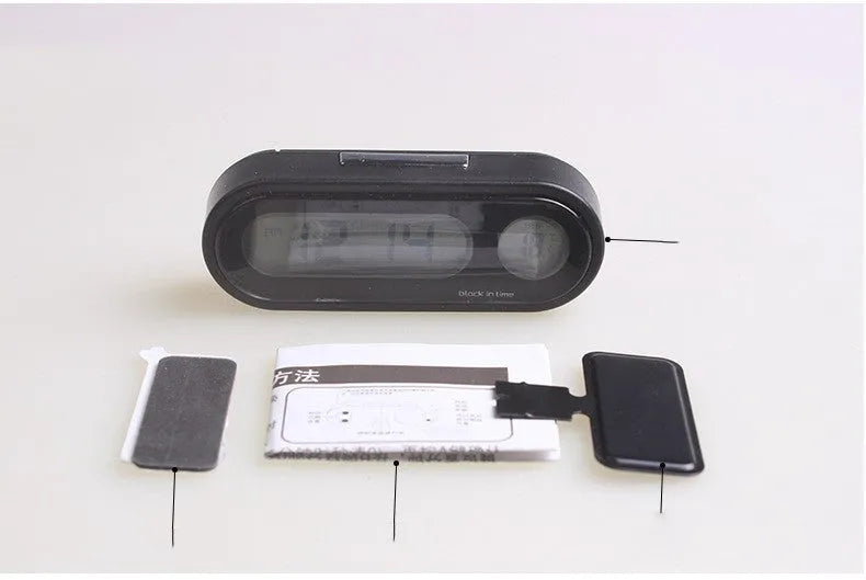 Black electronic car dashboard clock with LED display showing time and temperature