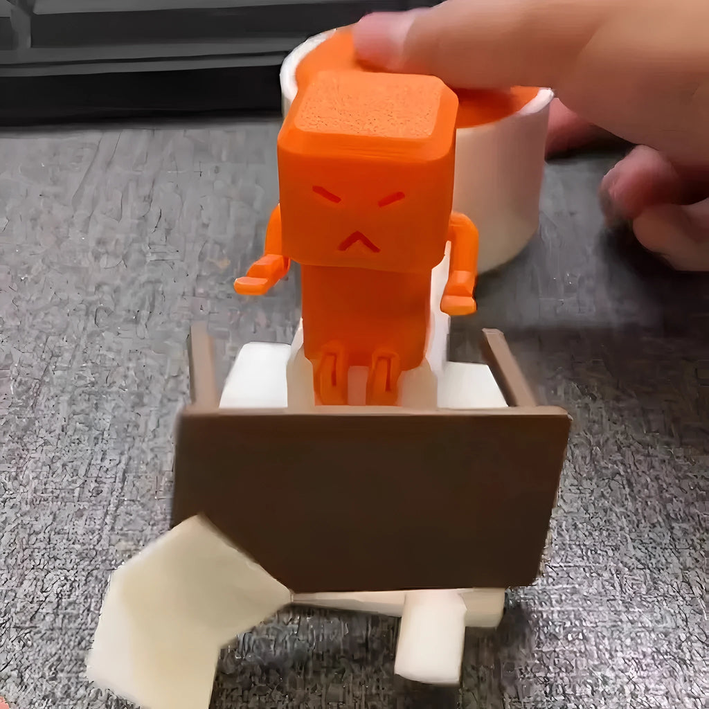 Orange plastic vent decompression fidget toy on a table, showing its 16cm length and turning mechanism.