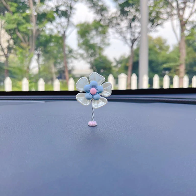 Small colourful plastic swing car decoration ornament in blue, green, pink, purple, or yellow.