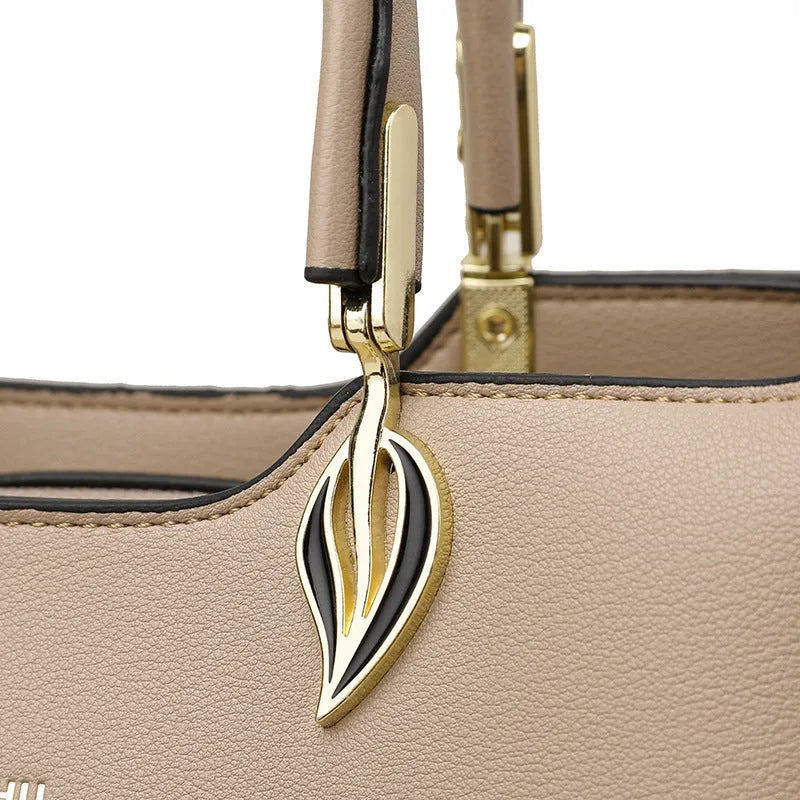 Women's black PU leather shoulder messenger bag with multi-layer compartments and visible stitching details
